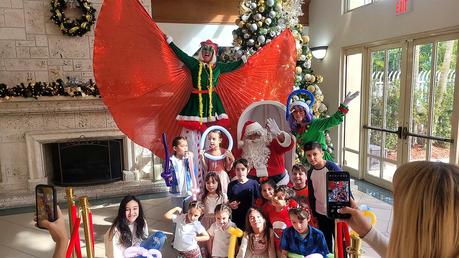 Papa Noel with children and entertainers at a community event