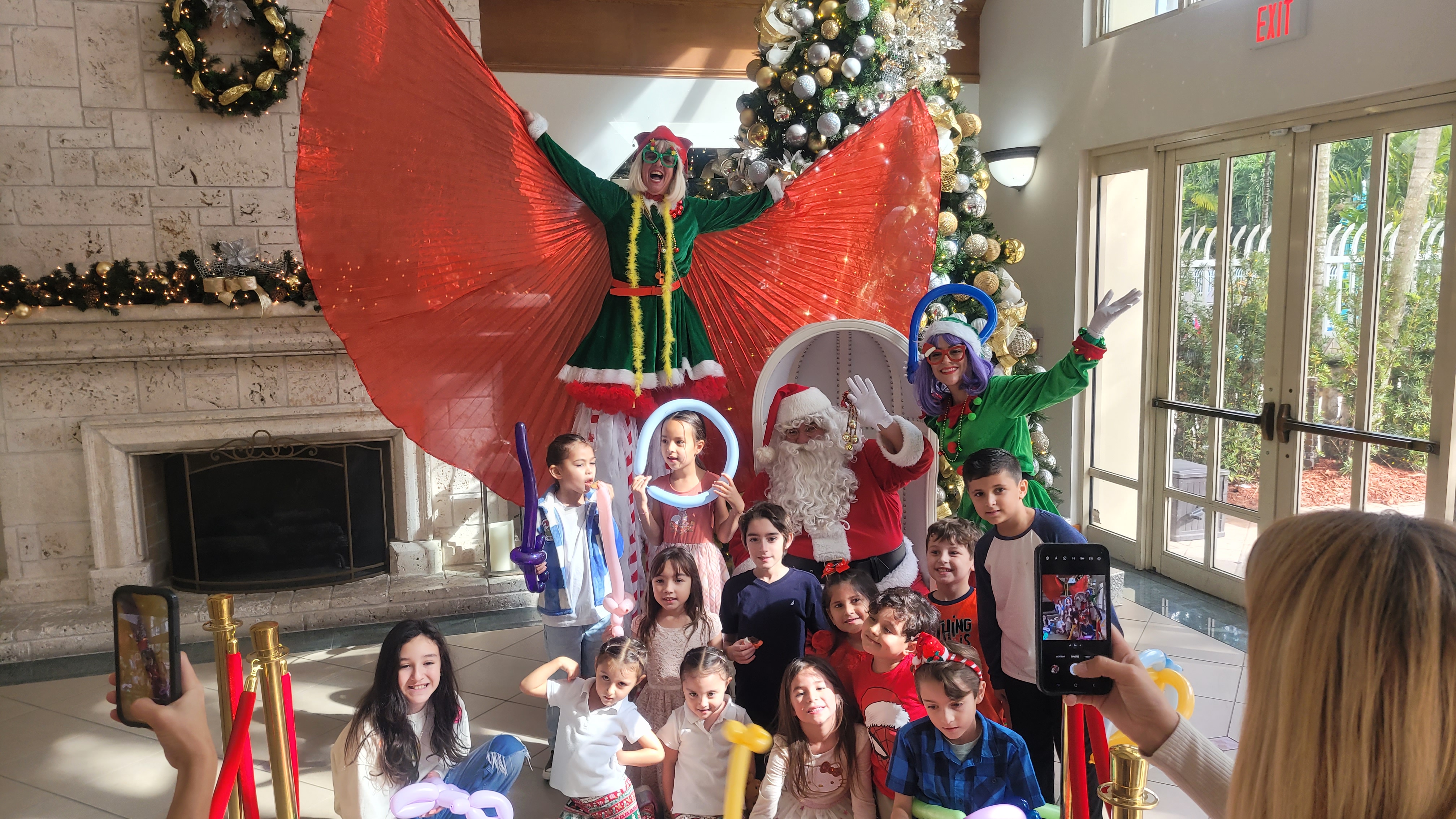 Papa Noel with children and entertainers at a community event